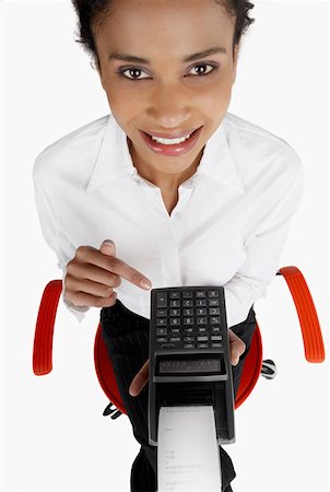 simsearch:625-01097830,k - High angle view of a businesswoman holding an adding machine tape and smiling Stock Photo - Premium Royalty-Free, Code: 625-01263683