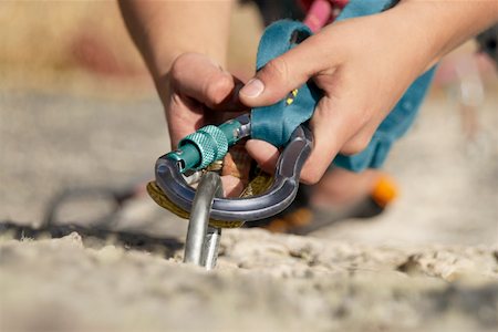 rock climbing closeup - Close-up of a rock climber concording a carabiner with a hook Stock Photo - Premium Royalty-Free, Code: 625-01744187