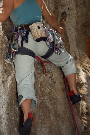 rock climbing closeup - Low angle view of a female rock climber climbing a rock Stock Photo - Premium Royalty-Free, Code: 625-01744203