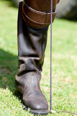 riding boots not equestrian not cowboy not child - Close-up of a person's leg wearing a riding boot Stock Photo - Premium Royalty-Free, Code: 625-01744542
