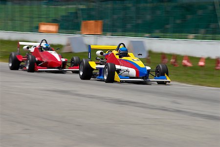 Two racecars racing on a motor racing track Stock Photo - Premium Royalty-Free, Code: 625-01744629
