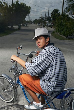 Portrait of a teenage boy cycling on a low rider bicycle Stock Photo - Premium Royalty-Free, Code: 625-01746728