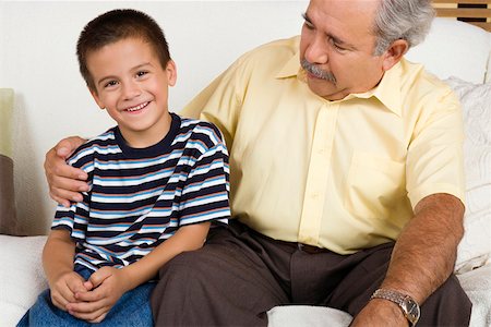 simsearch:400-06142278,k - Portrait of a boy sitting with his grandfather on a couch and smiling Stock Photo - Premium Royalty-Free, Code: 625-01746895