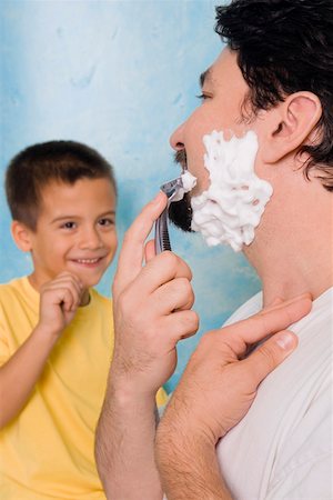 father and son shaving - Boy looking at his father shaving in the bathroom Stock Photo - Premium Royalty-Free, Code: 625-01747089