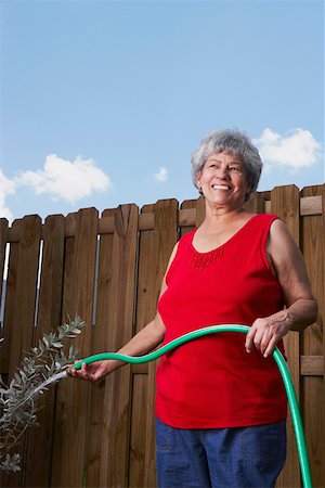 farming generation photography - Senior woman watering a plant Stock Photo - Premium Royalty-Free, Code: 625-01747124