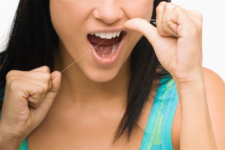 dental floss - Close-up of a young woman flossing her teeth Stock Photo - Premium Royalty-Free, Code: 625-01747164