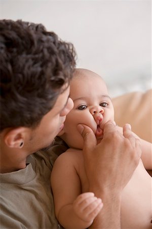 simsearch:625-02929316,k - Close-up of a young man playing with his son Stock Photo - Premium Royalty-Free, Code: 625-01747261