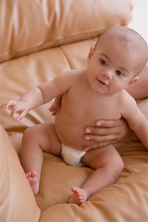 Close-up of a baby boy sitting on a couch Stock Photo - Premium Royalty-Free, Code: 625-01747274