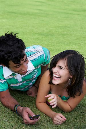 Close-up of a young couple lying in a lawn and smiling Stock Photo - Premium Royalty-Free, Code: 625-01747278