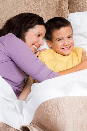 simsearch:6108-06907900,k - High angle view of a mid adult woman hugging her son on the bed Stock Photo - Premium Royalty-Free, Code: 625-01747500