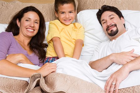 simsearch:6108-06907900,k - Portrait of a mid adult couple with their son on the bed Stock Photo - Premium Royalty-Free, Code: 625-01747514