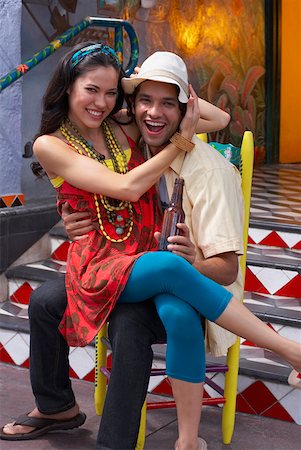 Portrait of a young woman sitting on the lap of a young man Stock Photo - Premium Royalty-Free, Code: 625-01747773