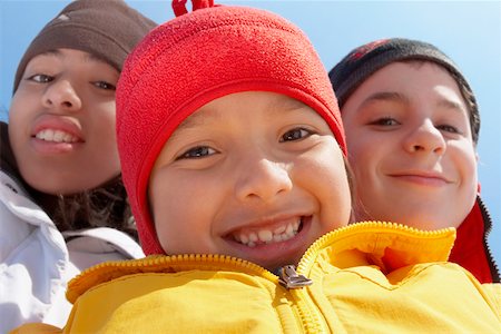 Portrait of a boy smiling with his two friends Stock Photo - Premium Royalty-Free, Code: 625-01747934