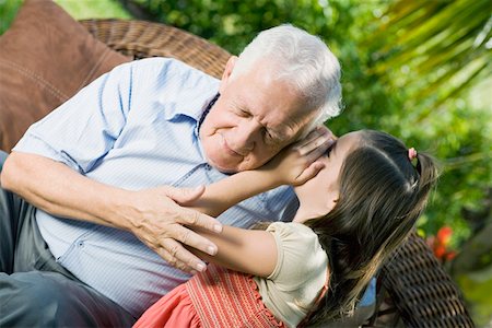 pictures of a little girl whispering - Girl whispering into her grandfather's ear Stock Photo - Premium Royalty-Free, Code: 625-01748154