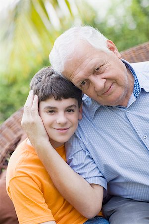 Portrait of a senior man with his grandson grinning Stock Photo - Premium Royalty-Free, Code: 625-01748214