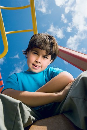 simsearch:625-01748893,k - Portrait of a boy sitting with his arms crossed on a jungle gym Stock Photo - Premium Royalty-Free, Code: 625-01748718
