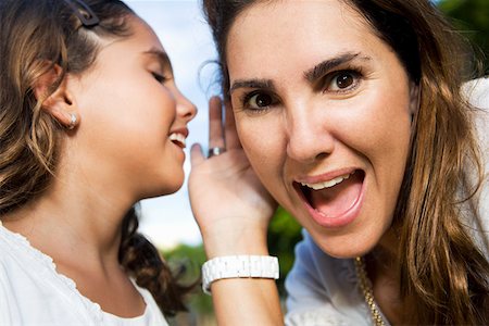 pictures of a little girl whispering - Close-up of a girl whispering into her mother's ear Stock Photo - Premium Royalty-Free, Code: 625-01748742