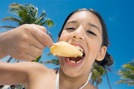 Portrait of a girl eating an ice- cream Stock Photo - Premium Royalty-Free, Code: 625-01748925
