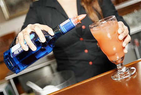 pourer - Mid section view of a young woman making a cocktail Stock Photo - Premium Royalty-Free, Code: 625-01749430