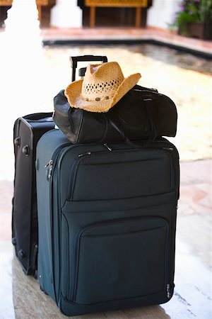 Close-up of a hand bag and a straw hat on a suitcase at the poolside, Cancun, Mexico Stock Photo - Premium Royalty-Free, Code: 625-01751868