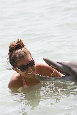 roatan - Teenage girl playing with a dolphin, Roatan, Bay Islands , Honduras Stock Photo - Premium Royalty-Free, Code: 625-01751973