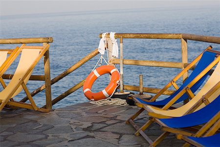 Deck chairs and a life belt on a pier, Capri, Campania, Italy Stock Photo - Premium Royalty-Free, Code: 625-01752045