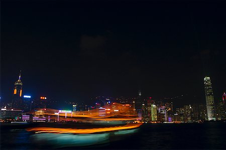 Skyscrapers lit up at night in a city, Victoria Harbor, Hong Kong Island, Hong Kong, China Stock Photo - Premium Royalty-Free, Code: 625-01752854