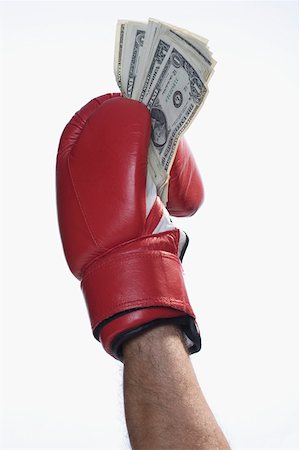 Male boxer's hand holding US dollar bills Stock Photo - Premium Royalty-Free, Code: 625-02265949