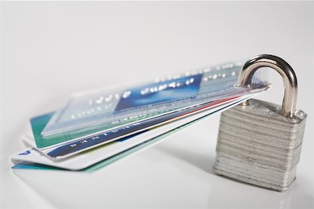 Close-up of credit cards with a padlock Stock Photo - Premium Royalty-Free, Code: 625-02265977