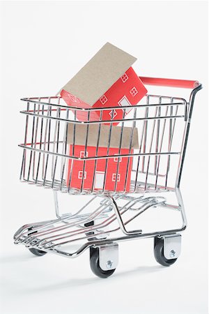 shopping cart white background - Close-up of two model homes in a shopping cart Stock Photo - Premium Royalty-Free, Code: 625-02266018