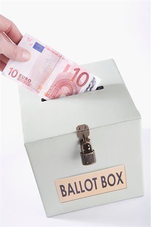 Close-up of a person's hand inserting ten euro banknote into a ballot box Stock Photo - Premium Royalty-Free, Code: 625-02266032