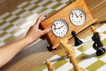 Close-up of a human hand pushing button of a chess clock Stock Photo - Premium Royalty-Free, Code: 625-02266371
