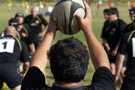 Rear view of a man holding a rugby ball Stock Photo - Premium Royalty-Free, Code: 625-02266387