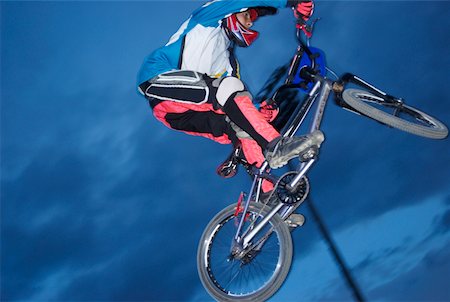 Low angle view of a BMX cyclist performing in mid-air Stock Photo - Premium Royalty-Free, Code: 625-02266440