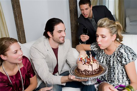 simsearch:625-01250196,k - Young woman celebrating a birthday party with her friends Stock Photo - Premium Royalty-Free, Code: 625-02266554