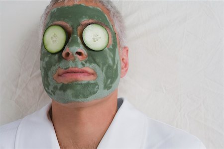 Close-up of a mature man lying on a massage table with facial mask on his face Stock Photo - Premium Royalty-Free, Code: 625-02266567