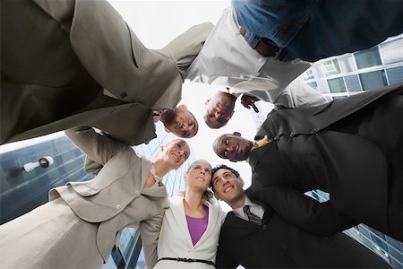 simsearch:625-02929600,k - Low angle view of a group of business executives standing in huddle Stock Photo - Premium Royalty-Free, Code: 625-02266576