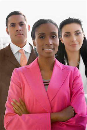 simsearch:625-02931998,k - Portrait of a businesswoman smiling with two business executives standing behind her Stock Photo - Premium Royalty-Free, Code: 625-02266870