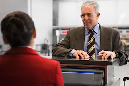 simsearch:625-02931717,k - Businessman at a ticket counter in an airport Stock Photo - Premium Royalty-Free, Code: 625-02266902