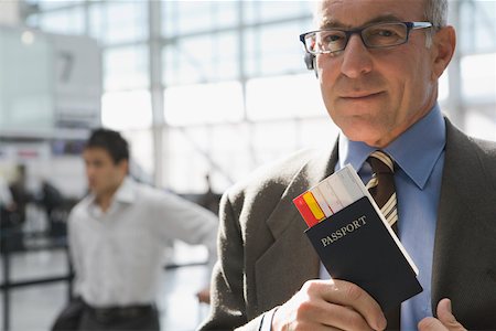 simsearch:625-02931998,k - Close-up of a businessman putting a passport with an airplane ticket in his coat's pocket Stock Photo - Premium Royalty-Free, Code: 625-02266922