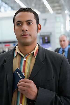 simsearch:625-02931717,k - Close-up of a businessman putting a passport in his coat's pocket Stock Photo - Premium Royalty-Free, Code: 625-02266944