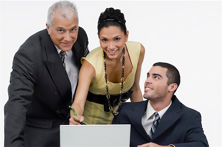 simsearch:630-03479740,k - Two businessmen and a businesswoman discussing on a laptop in an office Stock Photo - Premium Royalty-Free, Code: 625-02266971