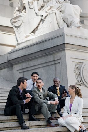 simsearch:625-02931998,k - Four businessmen and a businesswoman sitting on steps and discussing Stock Photo - Premium Royalty-Free, Code: 625-02267085