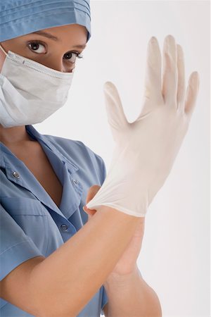 simsearch:625-02929180,k - Female surgeon wearing a surgical glove Stock Photo - Premium Royalty-Free, Code: 625-02267292