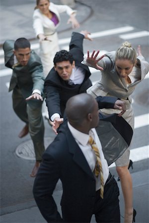expressions of fear - High angle view of business executives chasing a businessman Foto de stock - Sin royalties Premium, Código: 625-02267310