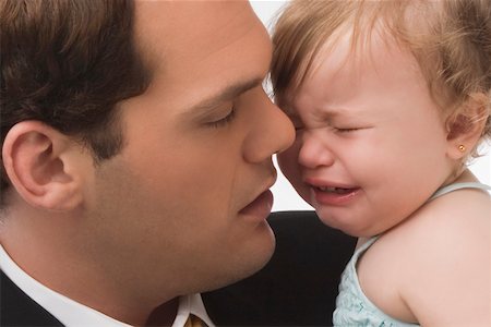 depressed young man - Close-up of a young man consoling his daughter Stock Photo - Premium Royalty-Free, Code: 625-02267326