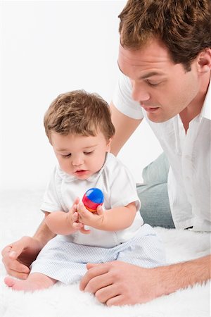 simsearch:625-02929316,k - Close-up of a young man playing with his son Stock Photo - Premium Royalty-Free, Code: 625-02267353