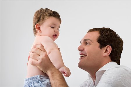 simsearch:625-02929316,k - Close-up of a young man playing with his son Stock Photo - Premium Royalty-Free, Code: 625-02267473
