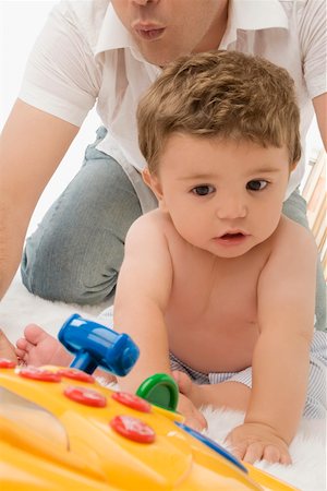 simsearch:625-02929316,k - Close-up of a young man playing with his son Stock Photo - Premium Royalty-Free, Code: 625-02267493