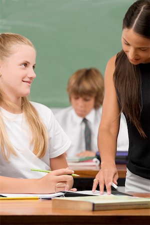 simsearch:614-06895765,k - Female teacher teaching a schoolgirl in a classroom Stock Photo - Premium Royalty-Free, Code: 625-02267677